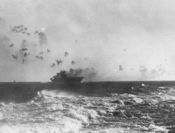 The American aircraft carrier USS Enterprise fighting off Japanese planes in 1942. The Enterprise was one of the carriers which had been a target of the Pearl Harbor attack, but had been out on a training mission with two other carriers at the time of the attack.