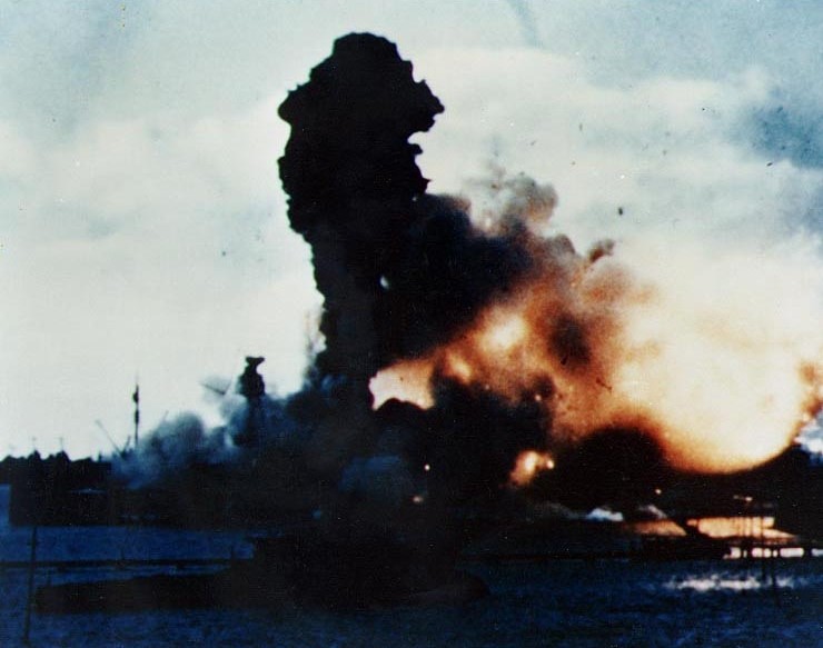 The USS Arizona on fire in Pearl Harbor.